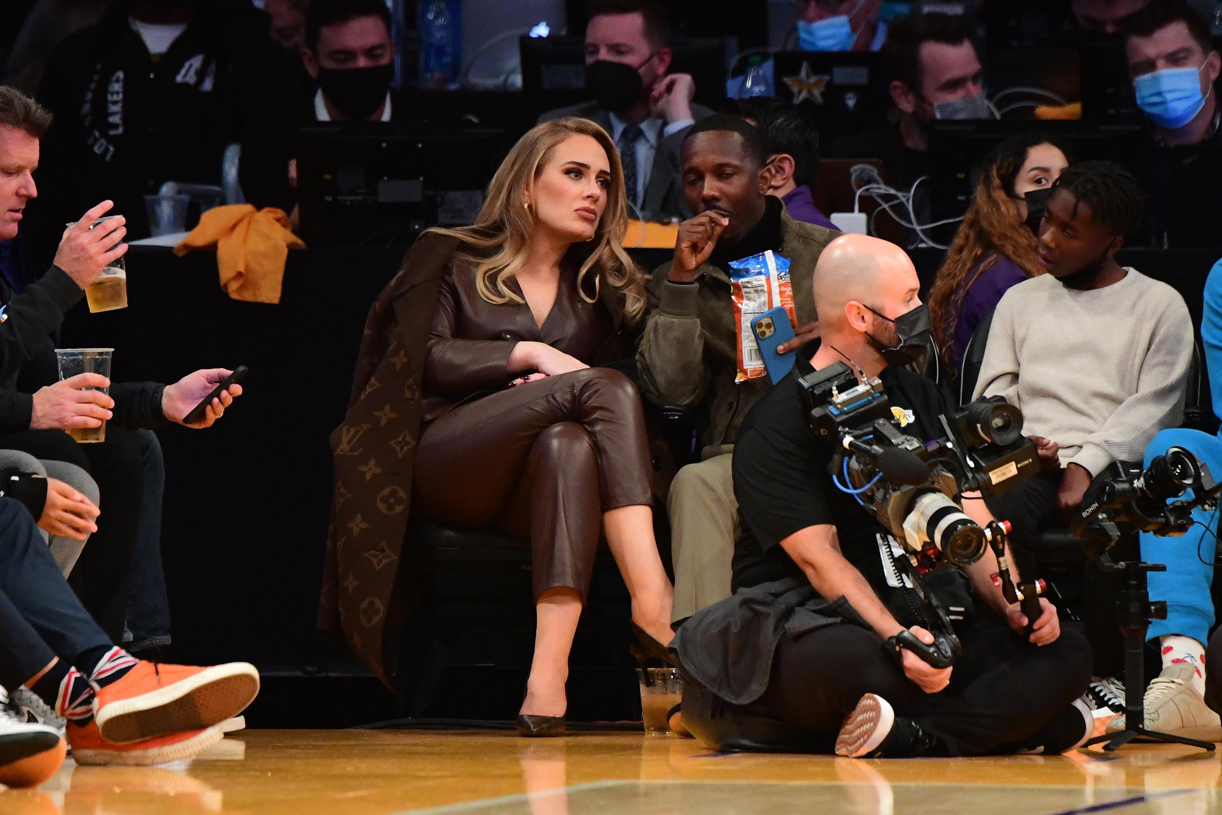 Adele, a Taurus, courtside in all designer